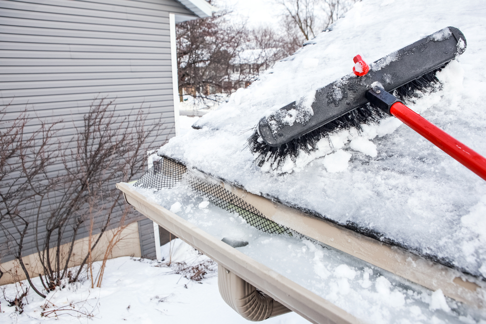 Gutters,With,Ice,Dam,And,Broom,For,Raking,Snow,Off
